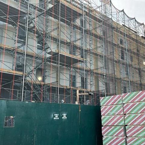 Street delivery at a scaffolded building